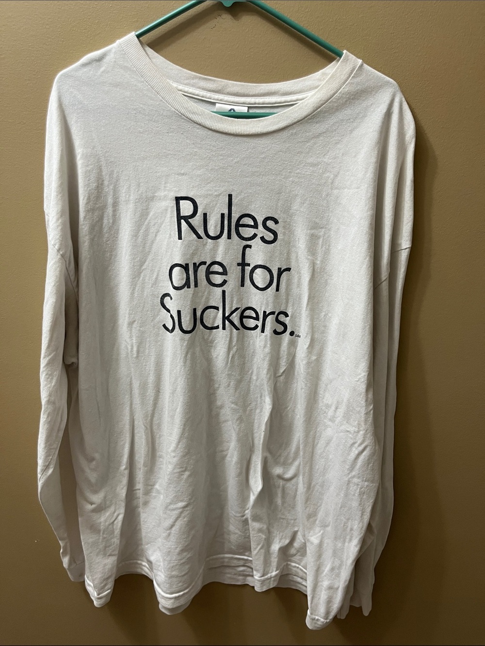 White Long-Sleeve Graphic Tee with 'Rules are for Suckers.'